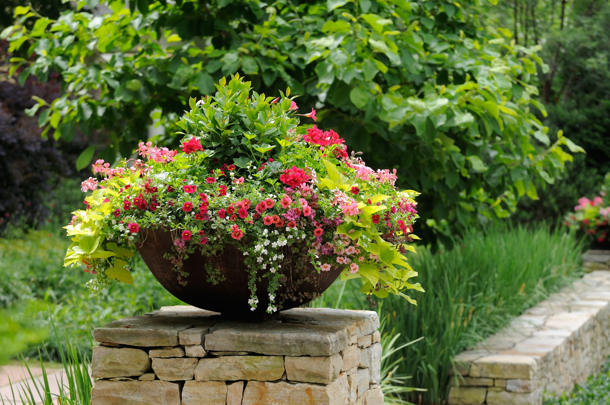 using pots in flower beds
