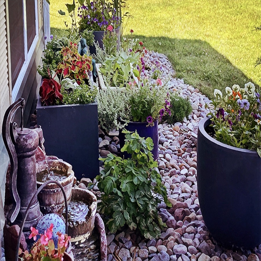 using pots in flower beds